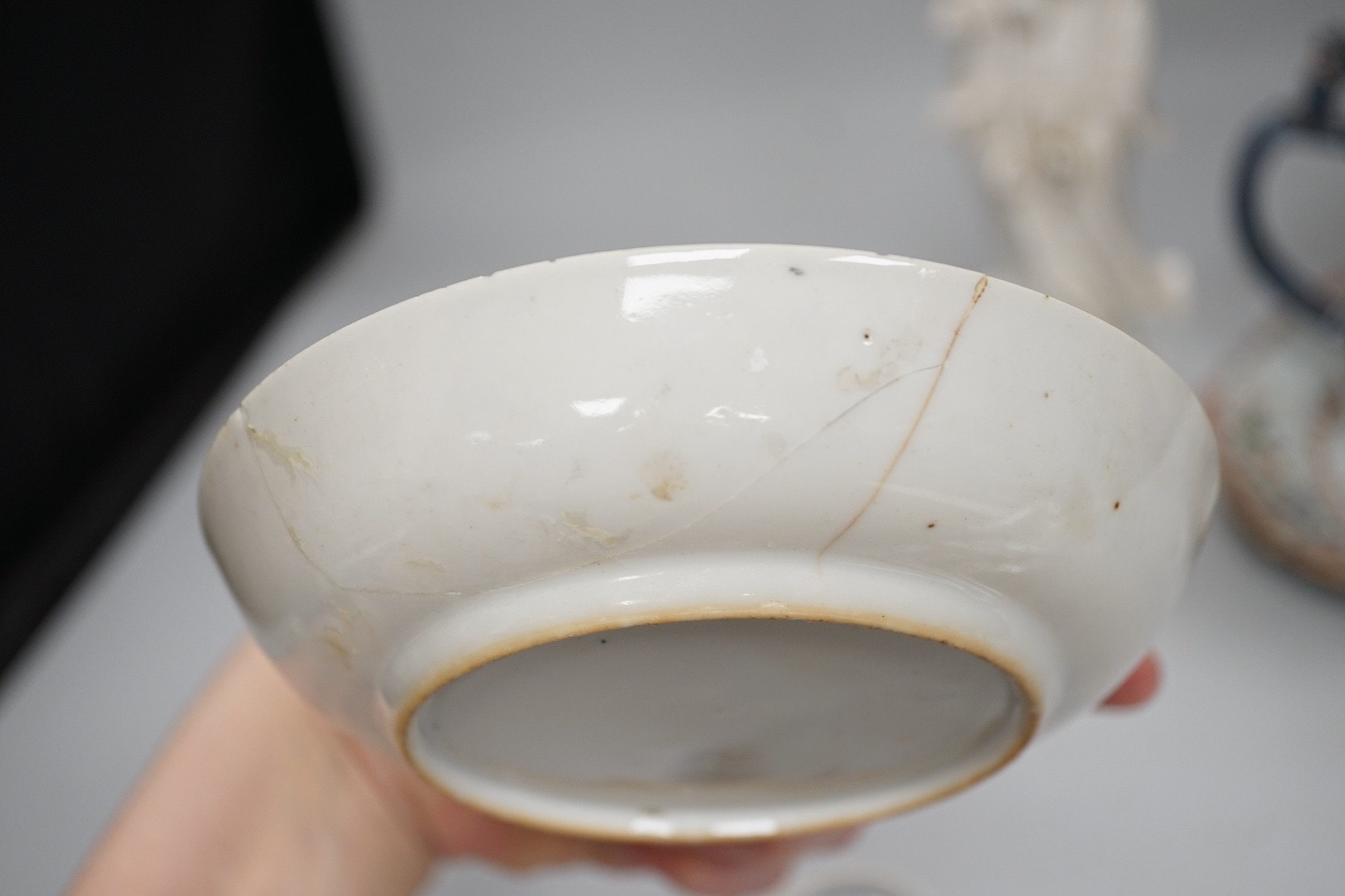 A Chinese figure of blanc de chine, a dragon tea bowl, a saucer, a large tankard, and another Chinese dish, tallest 23cm